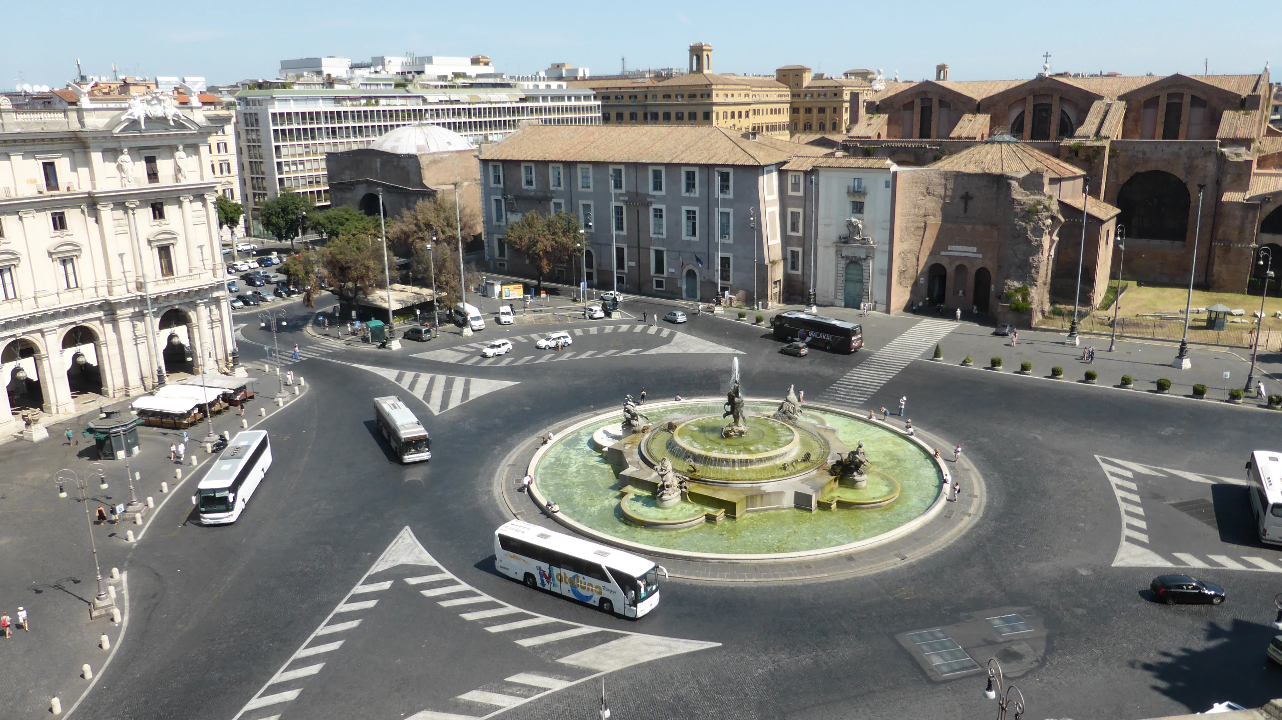 a town square with an arrangement of buildings and a clock