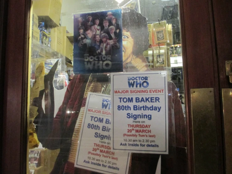 posters and flyers for the 10th birthday of actor tom baker are displayed in a shop window