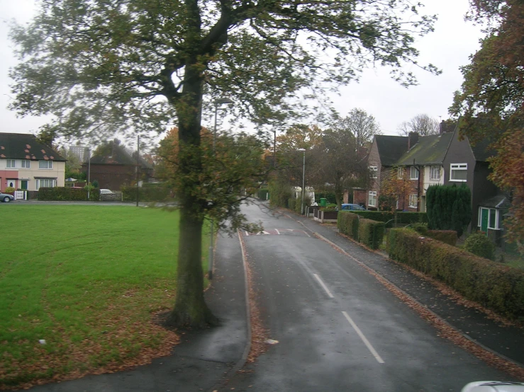 street intersection with street signs and houses in background