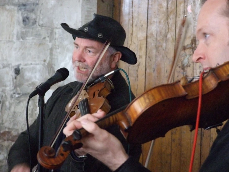 two men are playing music together with a microphone