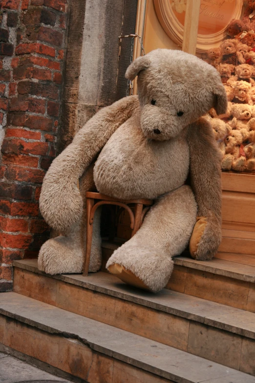 a very large teddy bear on some steps