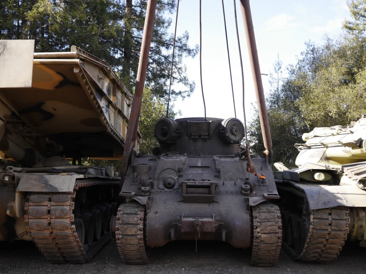 a couple of tanks sitting outside near trees