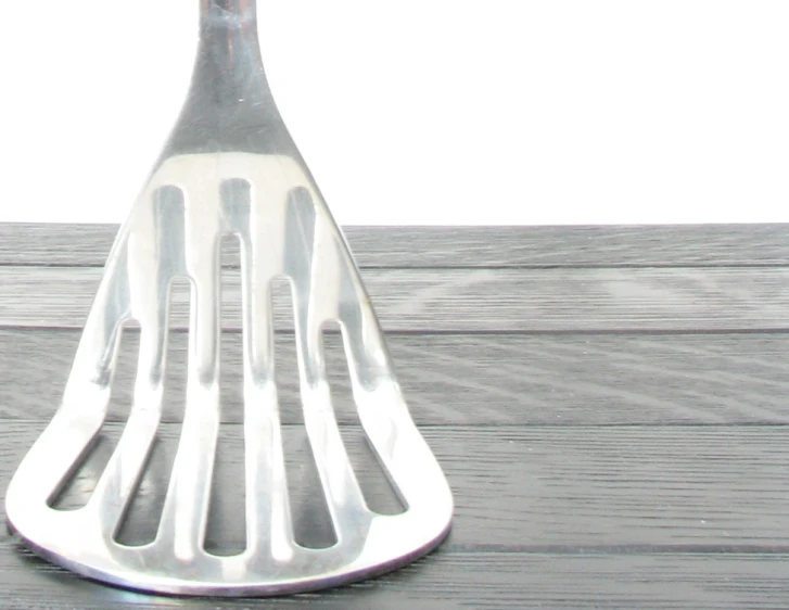 a fork on a wooden table with an object in the middle