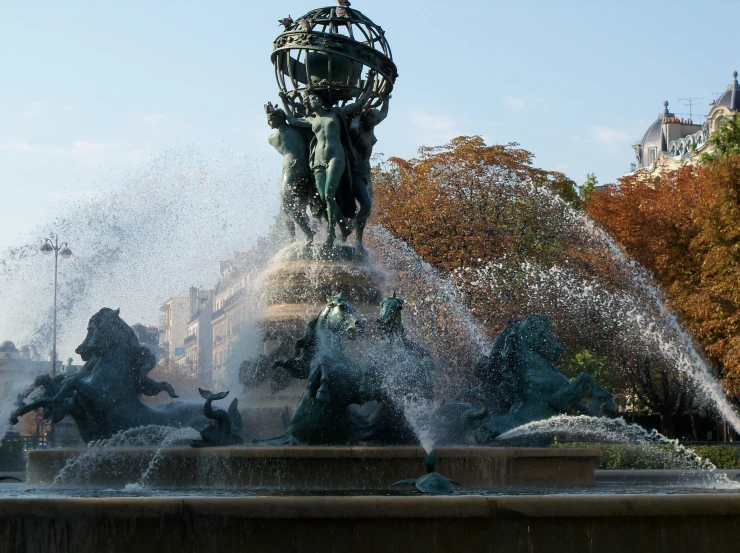 an image of a fountain in the city with water spewing from it