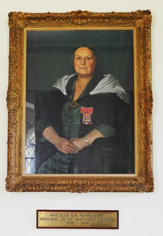 a portrait of a woman next to a plaque