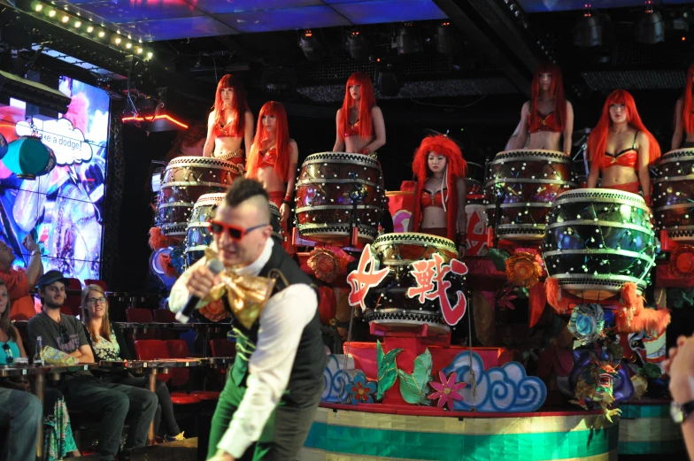 a man playing the drums in a crowded place