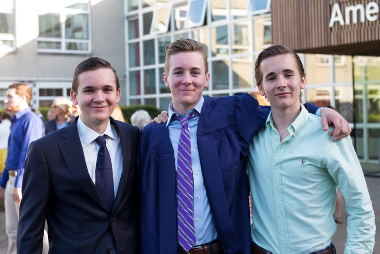 three men in suits posing for a picture