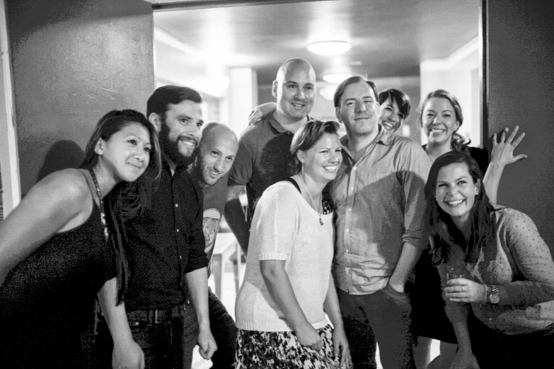 a group of people in an elevator posing for the camera