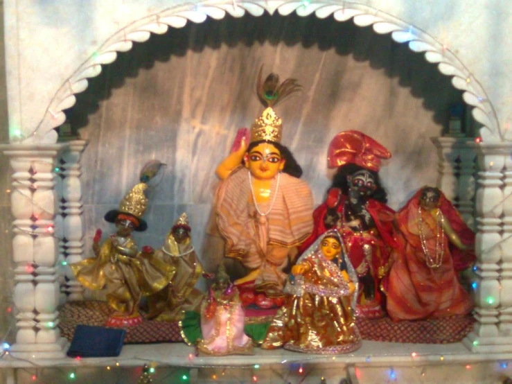 a display on a wall in a temple with colorful lights