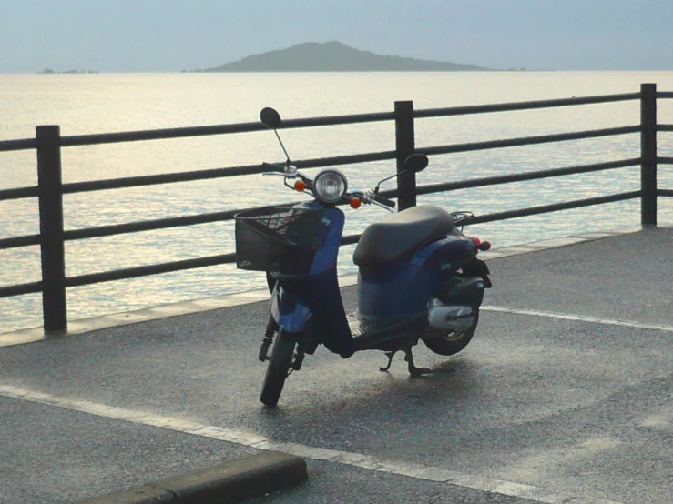 there is a moped parked near the ocean