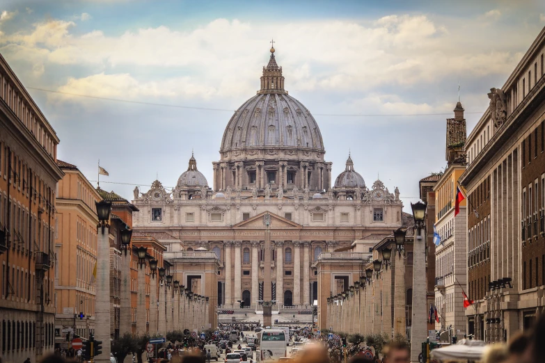 a large cathedral with many people walking on the street