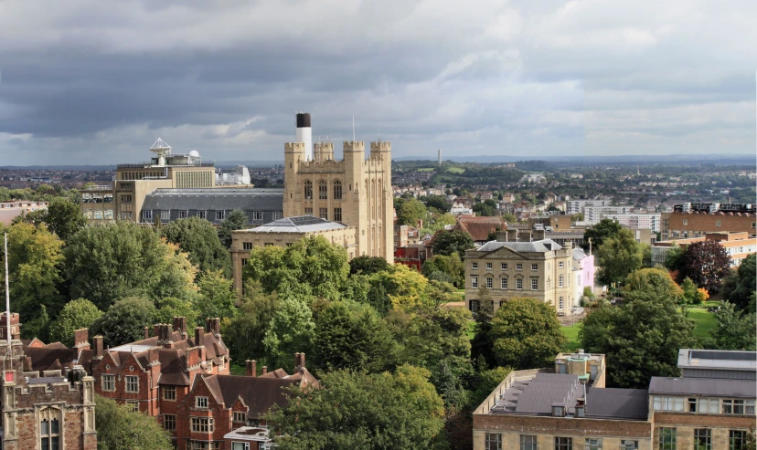 a scenic view of trees, buildings, and a dark sky