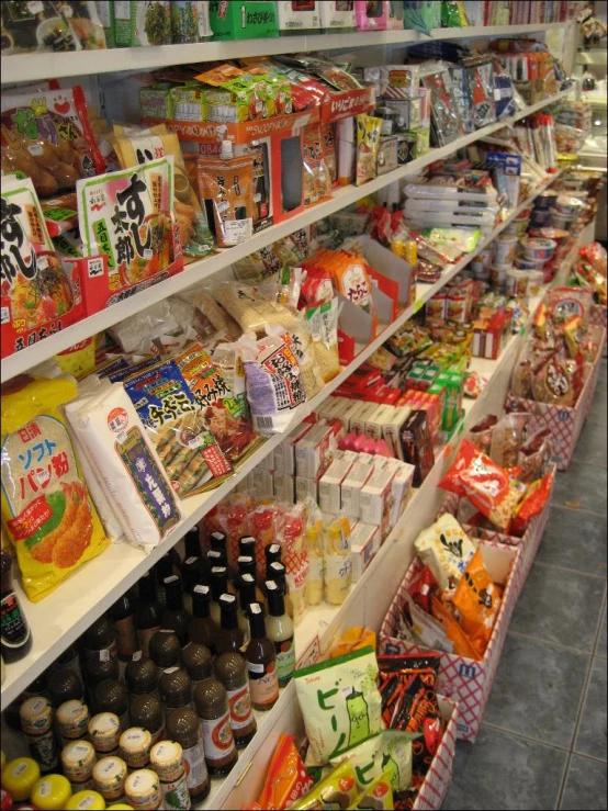 an aisle with several hanging shelf filled with various food items