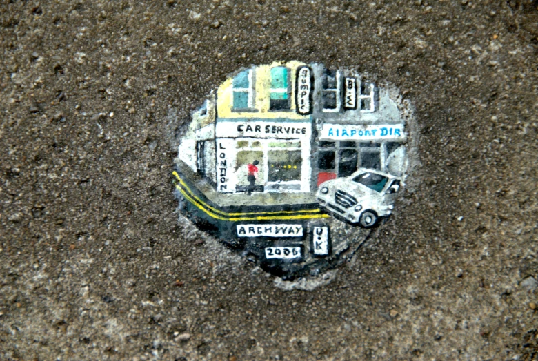a rock with cars on it in the middle of nowhere