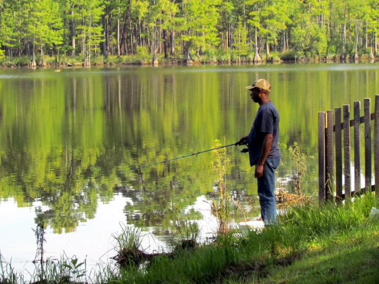 a man standing next to a body of water