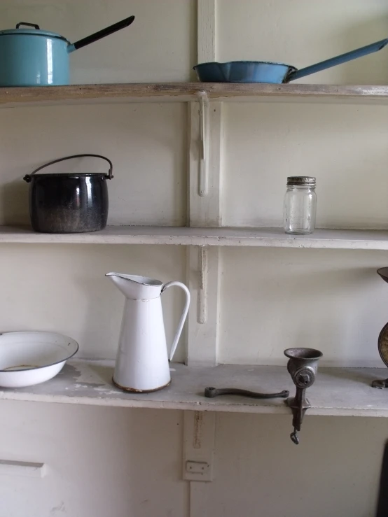 a wall full of pot and pans on shelves