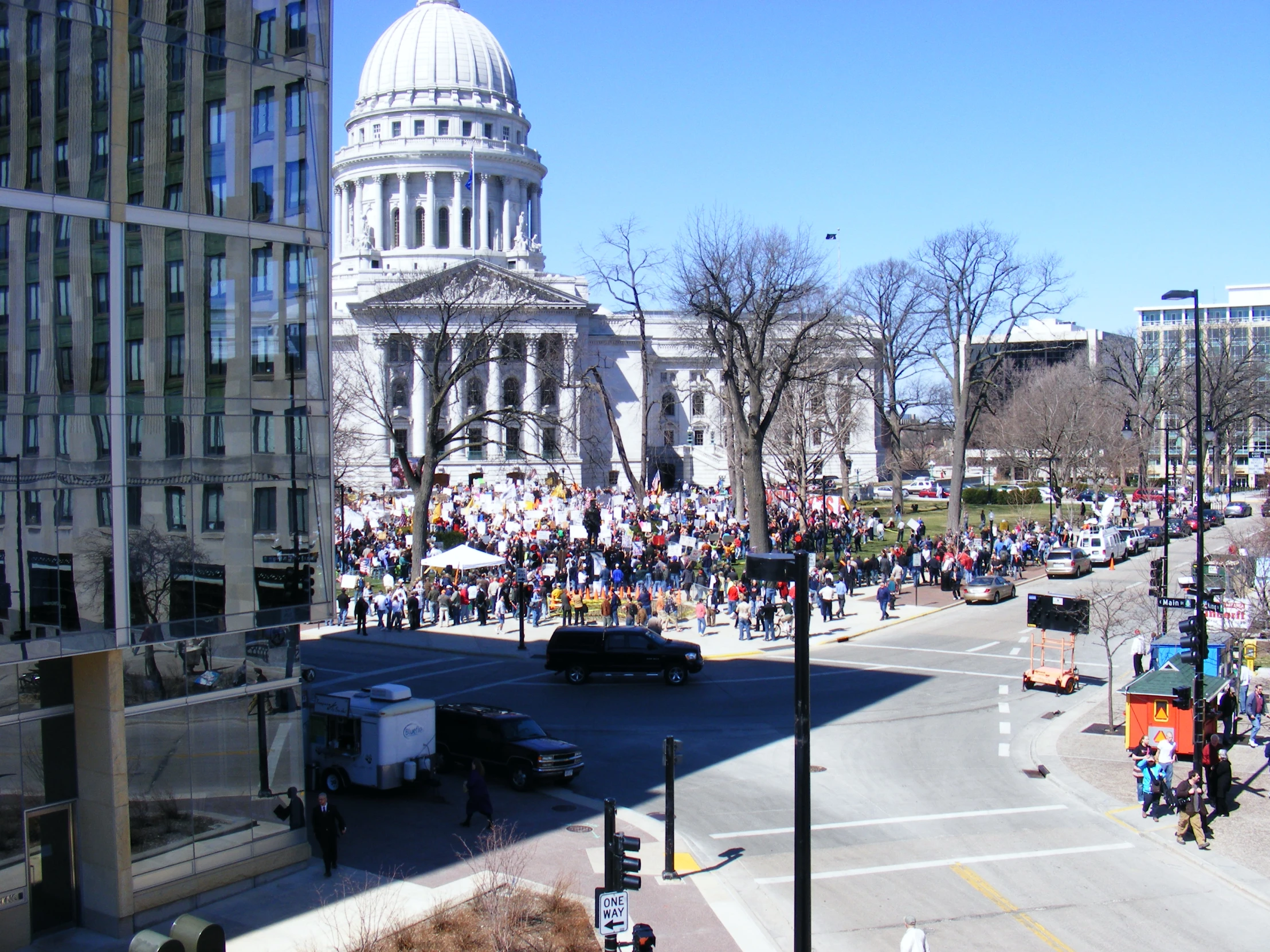 a large group of people walking down the street on a clear day