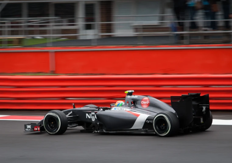 a man driving his race car on a track