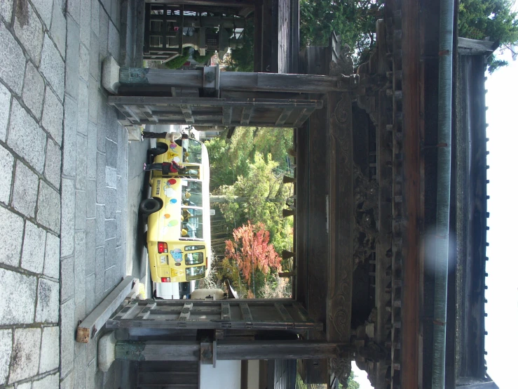 two large buses are parked in front of a temple
