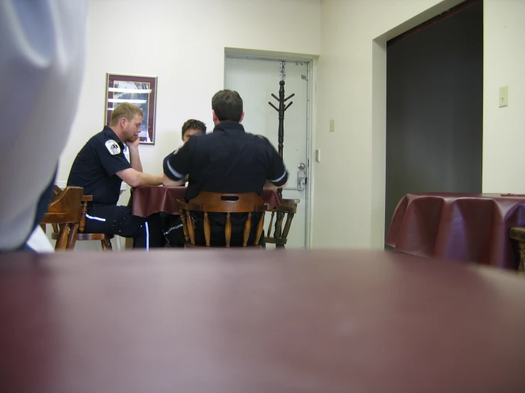 several people sitting around at tables in a room