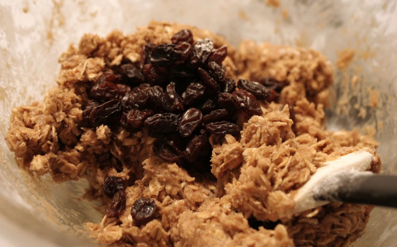 raisins and granola in a bowl with a spoon