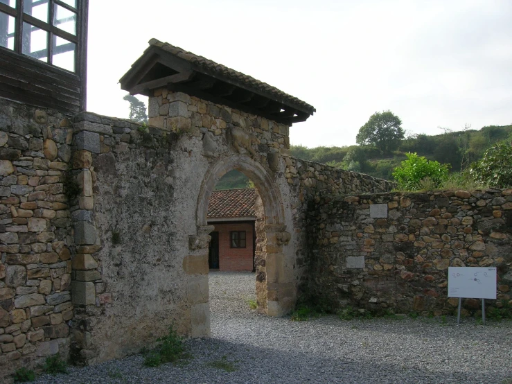 a cobblestone road leads to an old gate