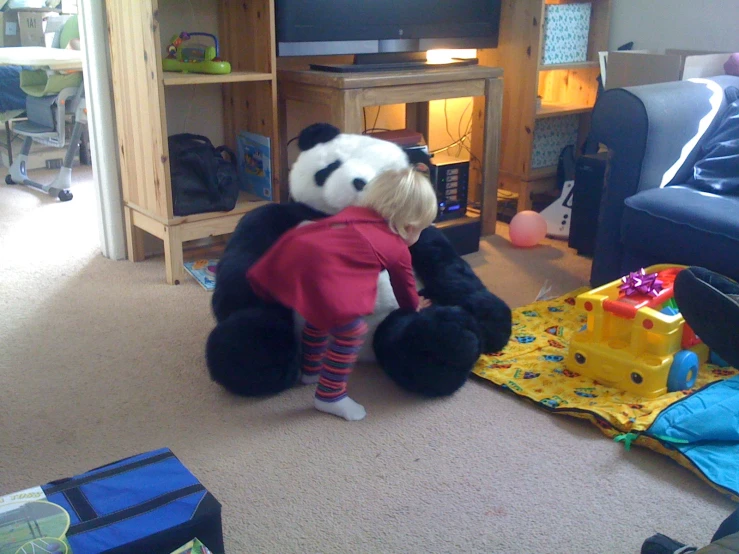 a stuffed panda bear sitting on top of a table