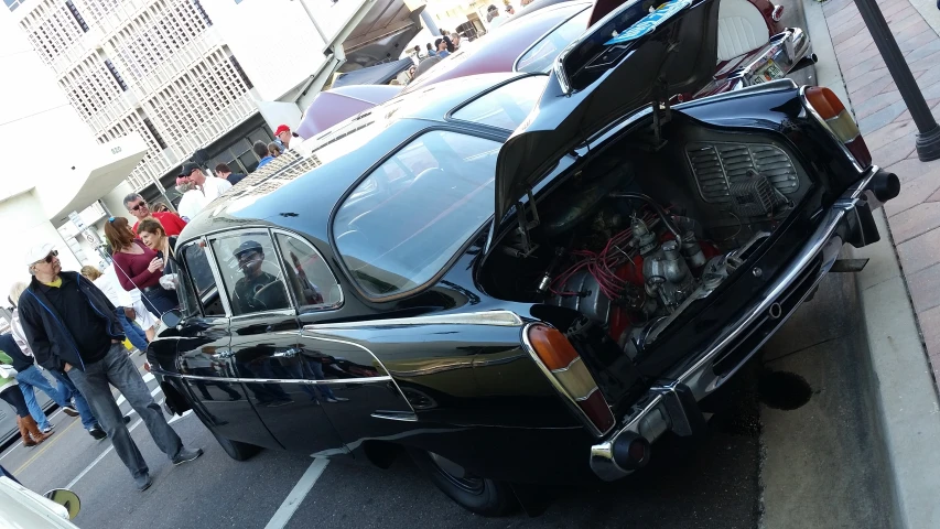 a car with its trunk open parked in a parking lot