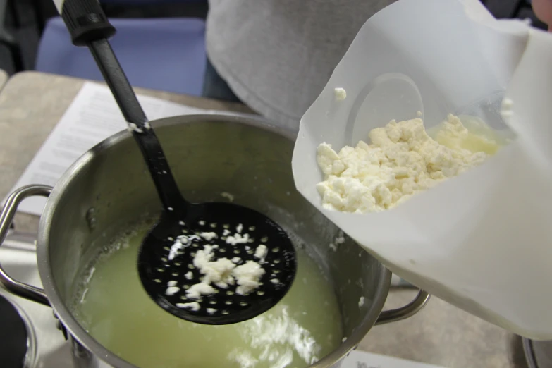 a bucket filled with lots of er next to a spoon