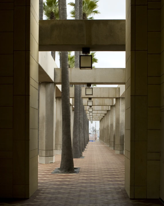 a long walk way with a clock hanging from the top