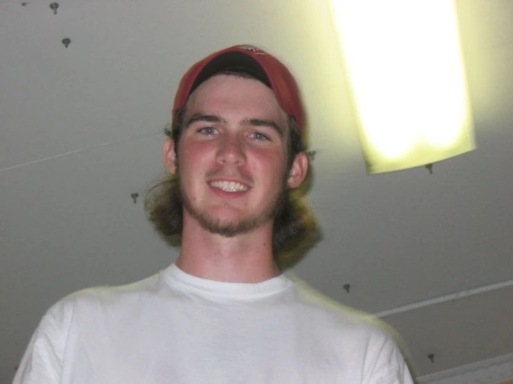 a man wearing a red cap and white shirt