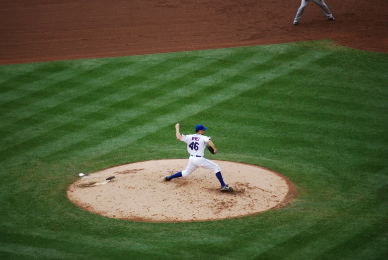 a pitcher winding up for a pitch during the baseball game