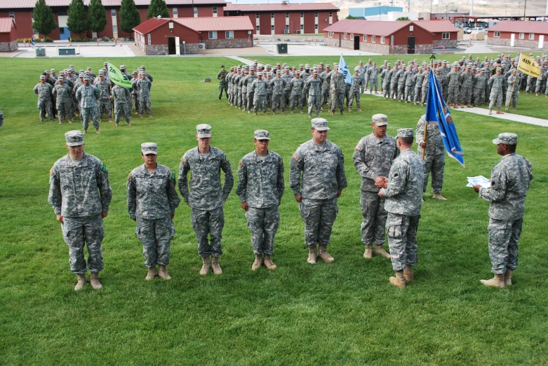 soldiers are at attention to the flag raising