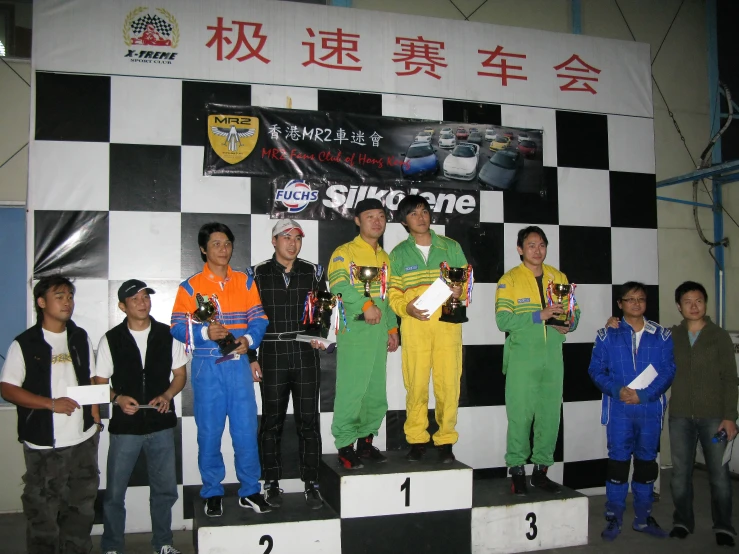 some men wearing sports uniforms standing on a podium