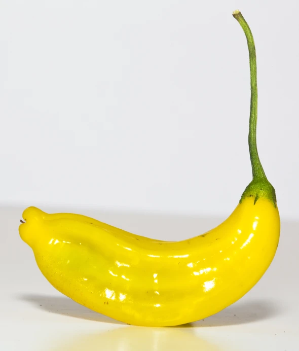 a banana sitting on a table near the wall