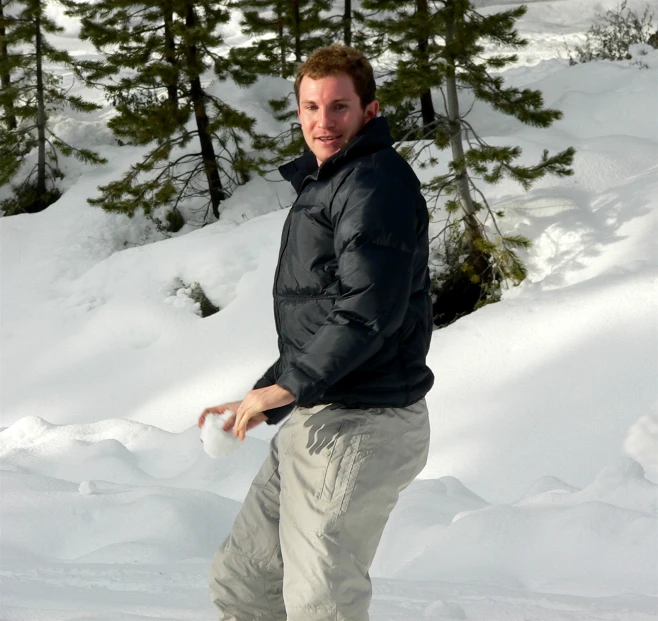 a man in winter gear snowboarding down a mountain