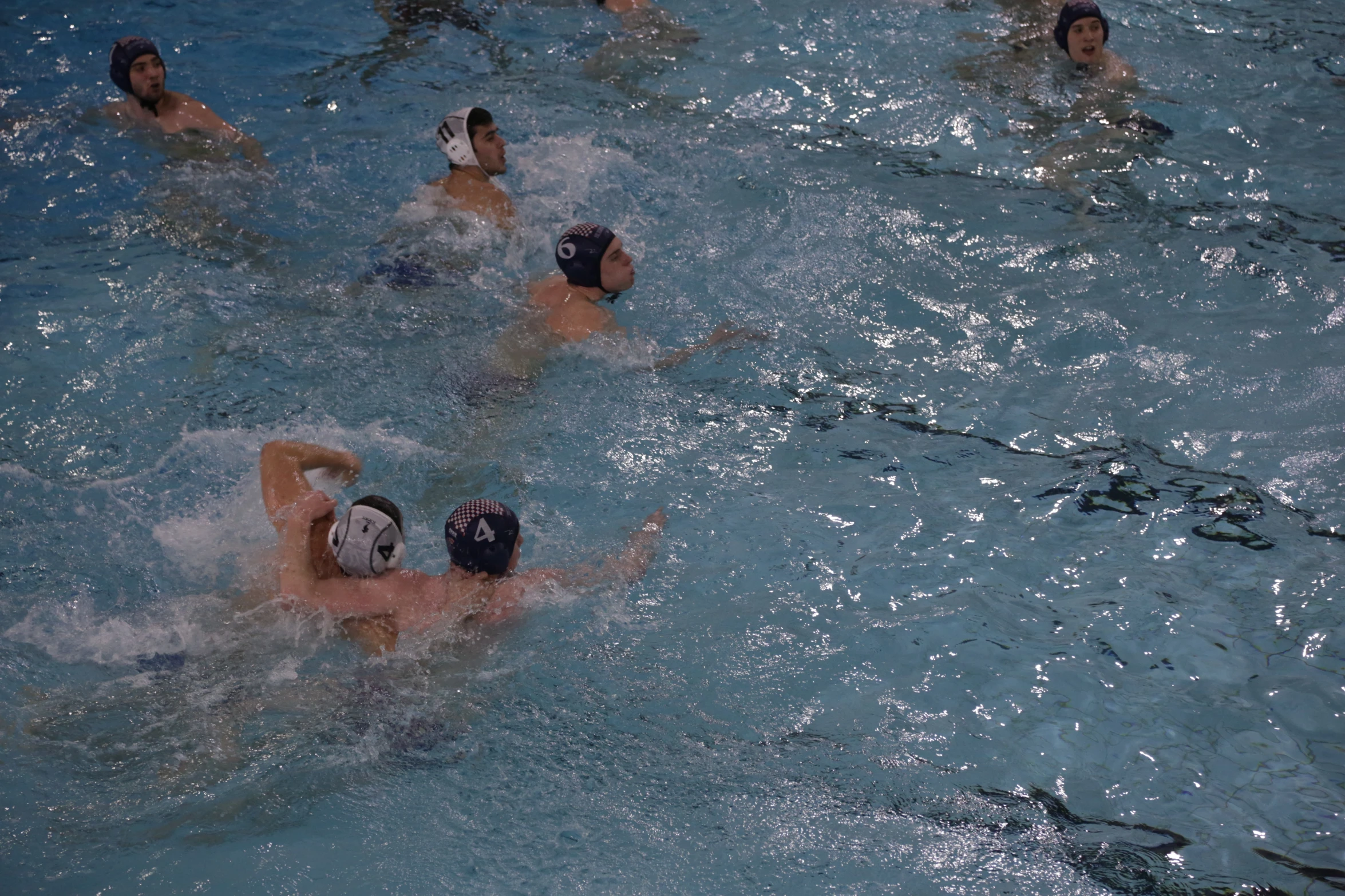 two teams of people playing in a water polo match