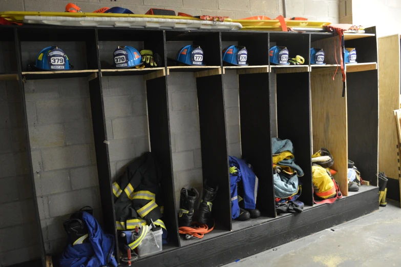 a room with shelves on either side and several different pairs of shoes hanging up from the wall