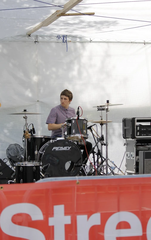 a man standing on a stage while playing musical instruments