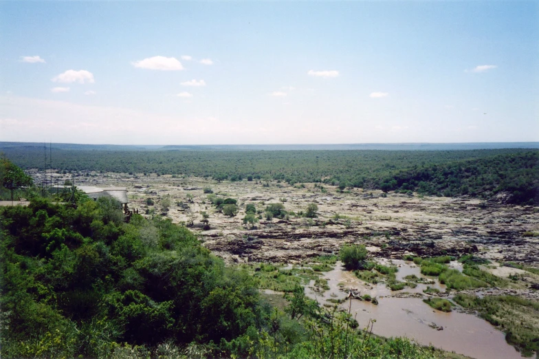 a view of a large area of land that is covered with rocks, grass, and trees