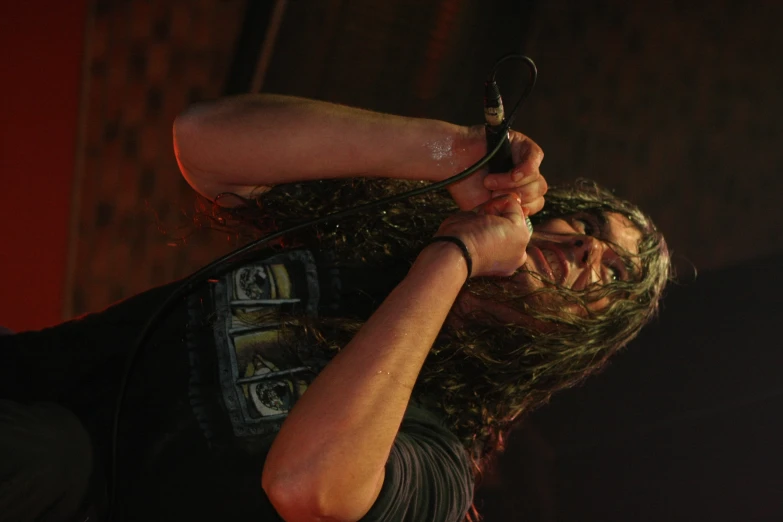 a male with a long hair on stage