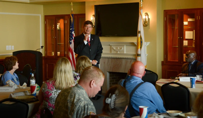 a man giving a talk to a group in a room