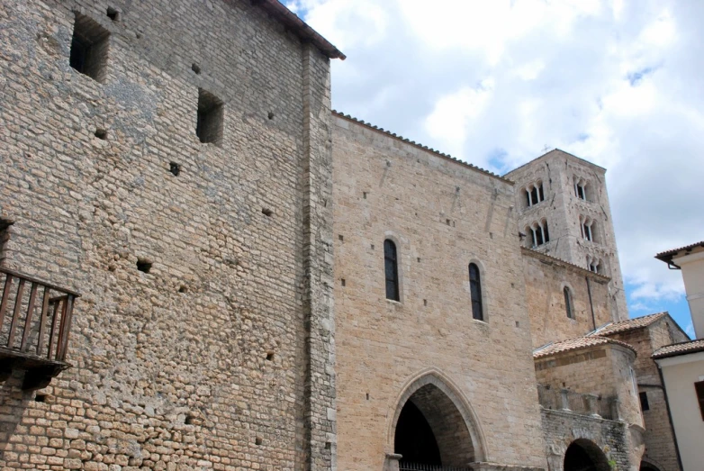 a very tall brick building with a tall tower