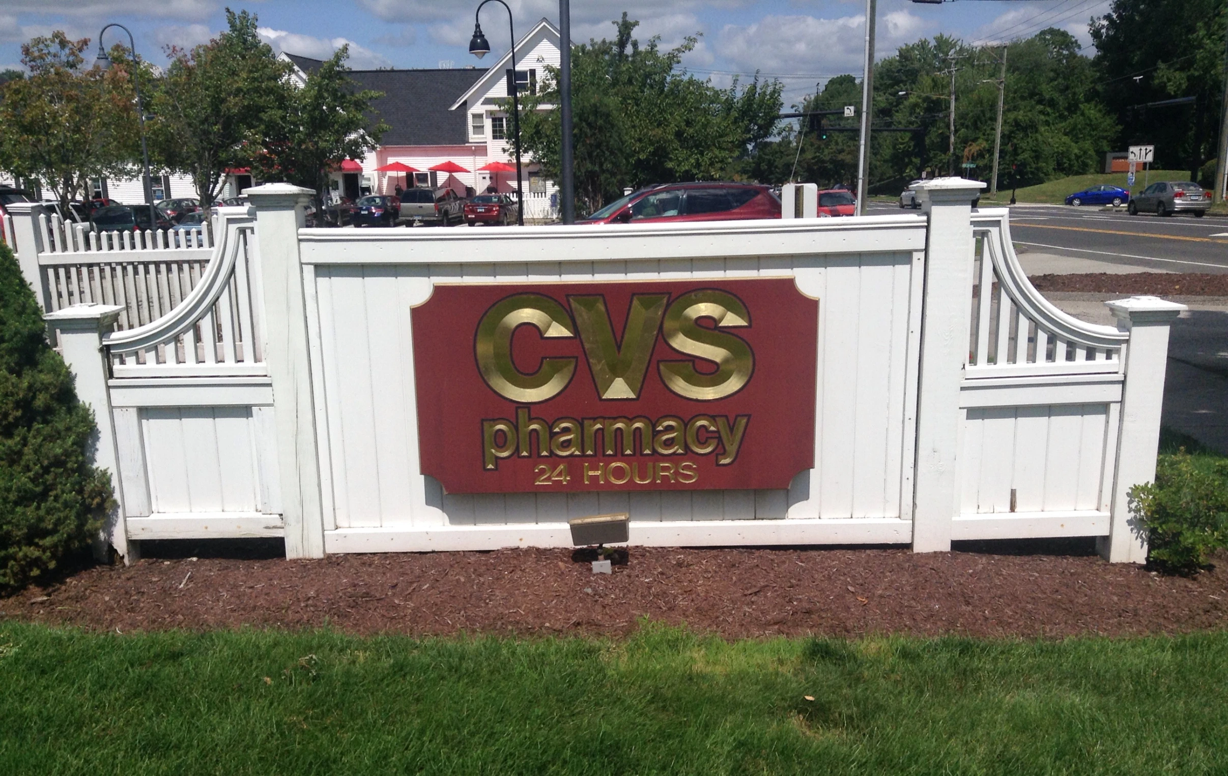 a business sign for a building near some bushes