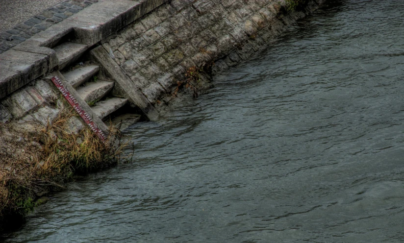 a building has several steps next to a lake