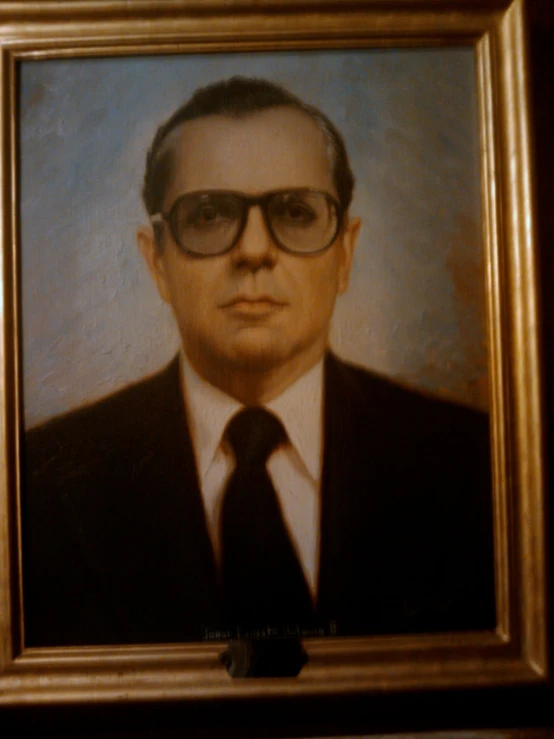 an antique portrait of a man wearing black suit and tie