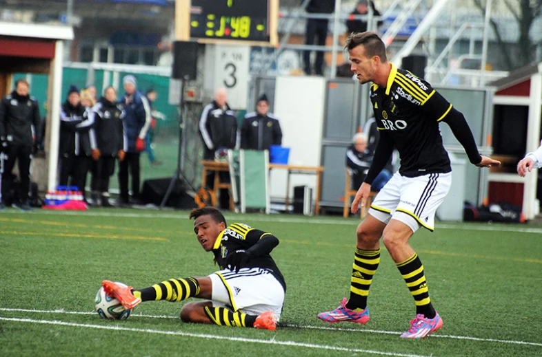 two soccer players and their team mates are preparing to play on a field