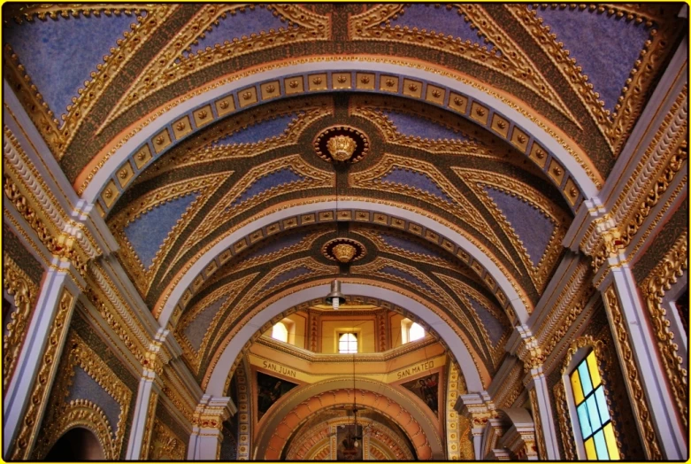 a church with an arched ceiling and stained glass windows