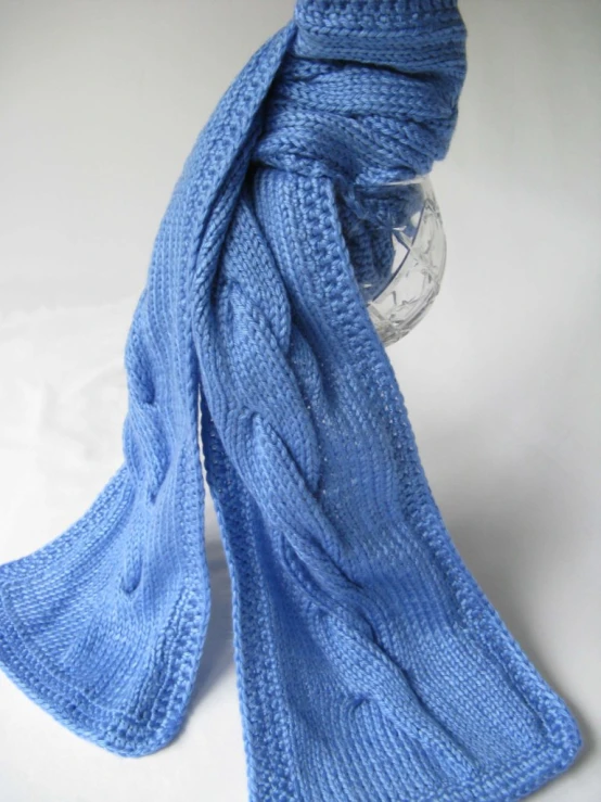 a blue scarf sitting on top of a table