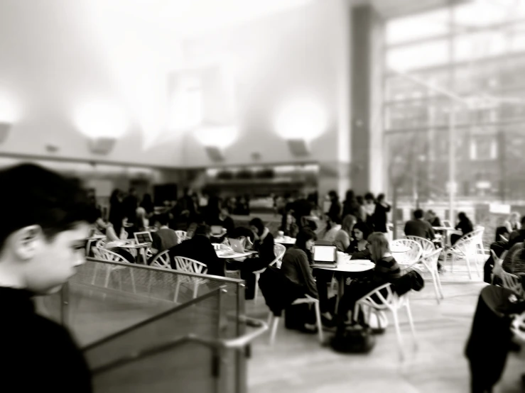 an image of people sitting at tables outside